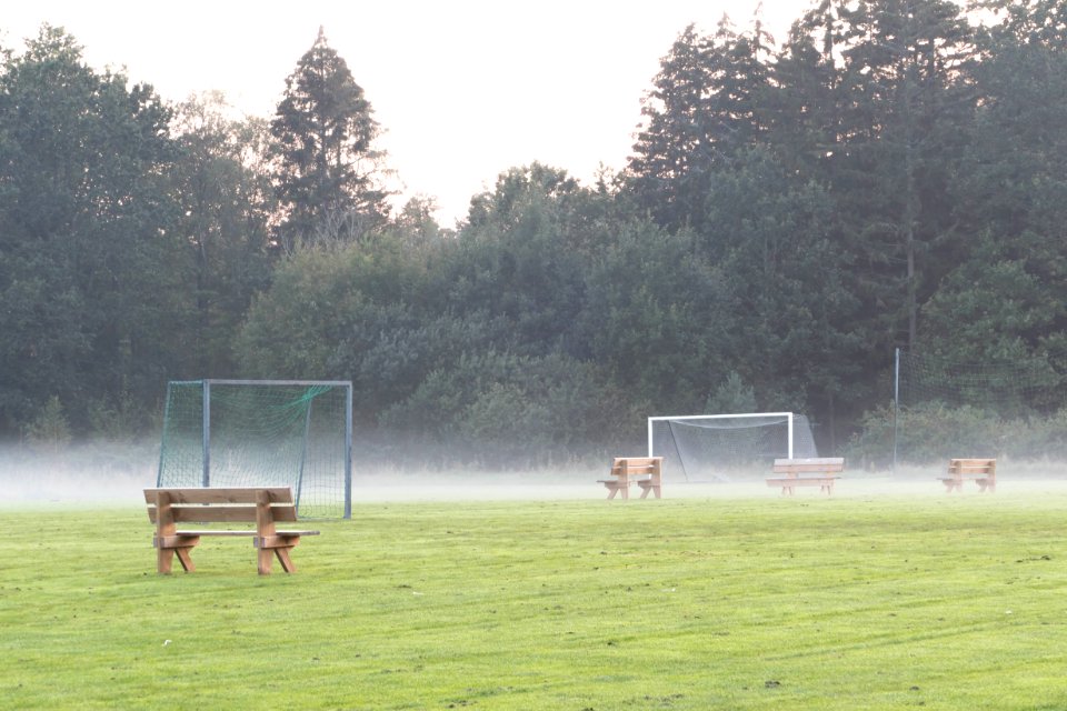 Benches in the mist in soccer training field 1