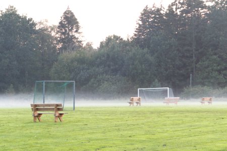 Benches in the mist in soccer training field 1 photo
