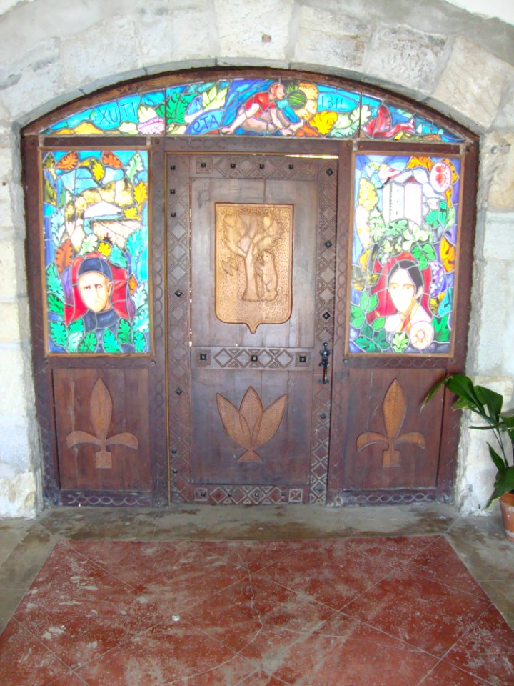 Arbonne (Pyr-Atl., Fr) stained glass and wood reliefs under the church portal