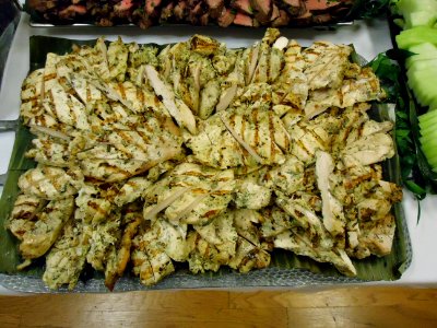 Chicken dish served on a rectangular tray at a party