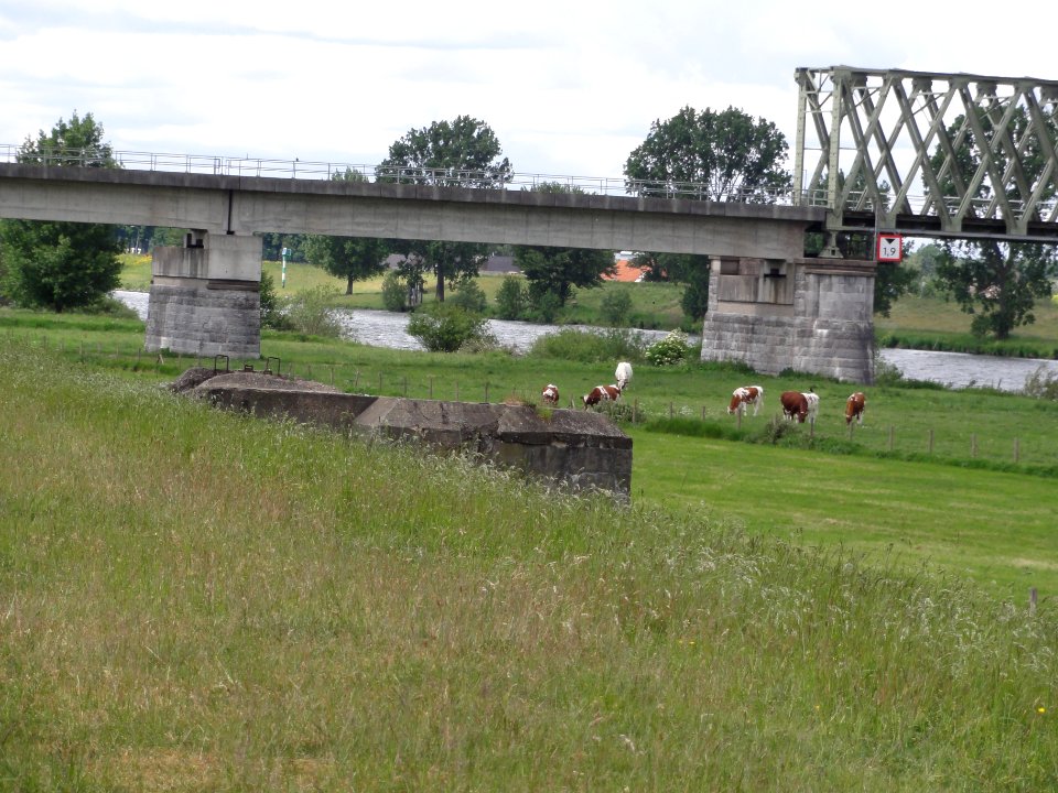 Cuijk Rijksmonument 420214 dozijn kazematten, nr 115 S met spoorbrug erachter