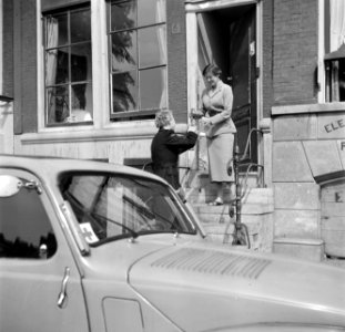 Zuster M.G. Niemeijer haalt een fles gekolfde moedermelk op bij mevrouw Snijders, Bestanddeelnr 254-2541