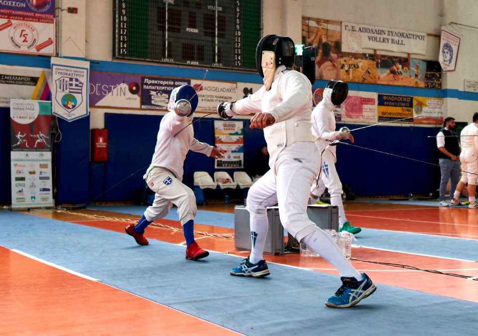 2nd Leonidas Pirgos Fencing Tournament. The fencer on the right performs an extension and scores a touch