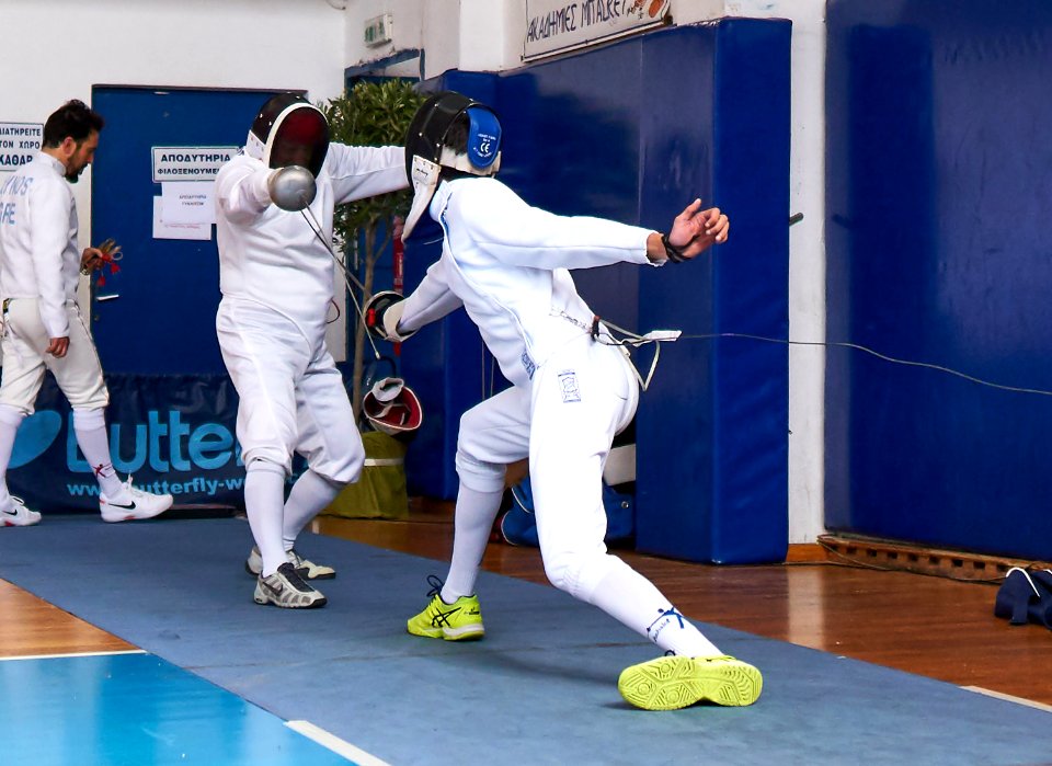 2nd Leonidas Pirgos Fencing Tournament. The fencer on the right scores a hand touch on the fencer on the left