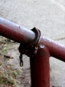 Handcuffs-on-rusty-handrail