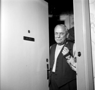 Dirk Nak met een sigaar in zijn hand in de deuropening, Bestanddeelnr 252-9013