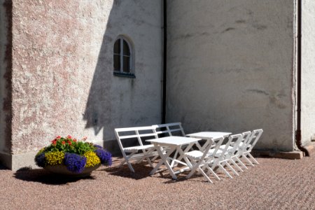 Corner of Bro Church, Lysekil with chiars and tables photo