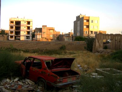 Destroyed red car in a abandoned zone nearnear amin eslami garden- Nishapur 2