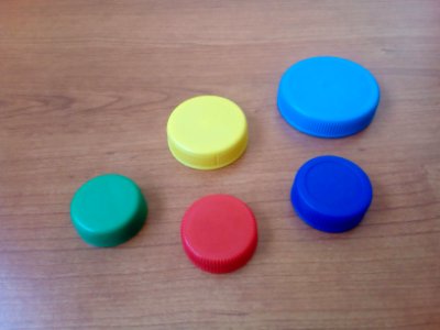 Five plastic bottle lids