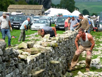 Dry stone wall building 07 photo
