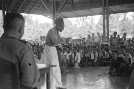 Een Javaanse man spreekt een grote groep Indonesiërs toe op een veranda., Bestanddeelnr 489-6-3