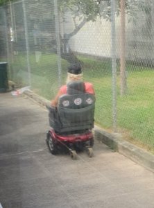 Person with "Protect Mauna Kea" and "No TMT" stickers, in Kaneohe