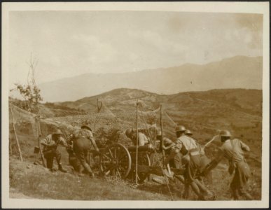 Mountain battery going into position. Two views show special screened roads, Bestanddeelnr 158-2174