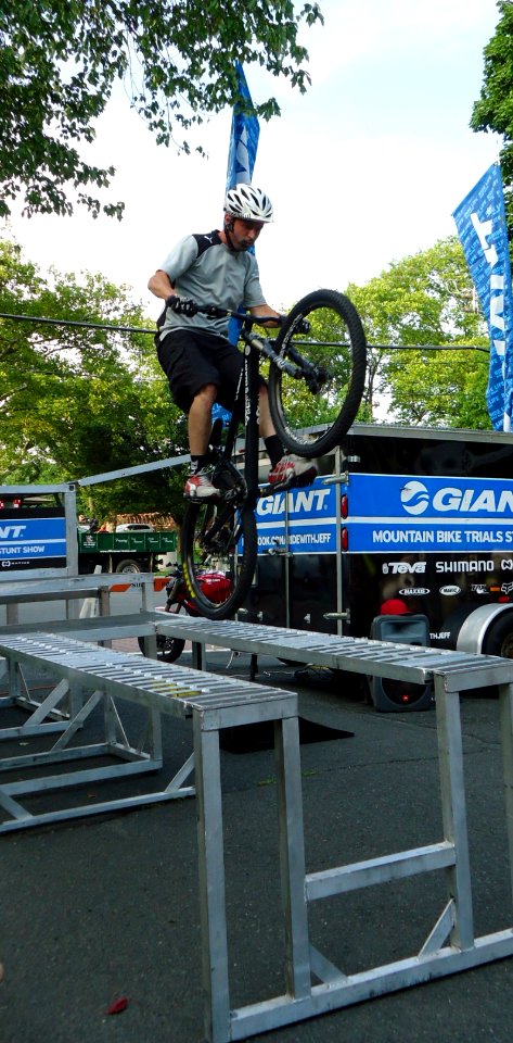Mountain bike stunt cyclist Chris Clark does a wheelie on ramps