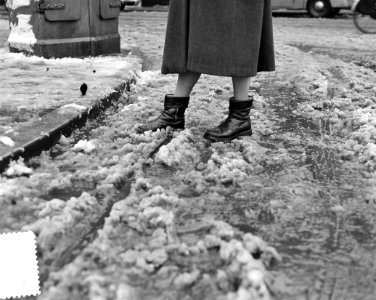 Moddergenoegens. Vrouw stapt door moddersneeuw, Bestanddeelnr 904-9555