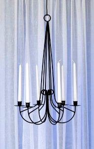 Modern iron chandelier with candles photo