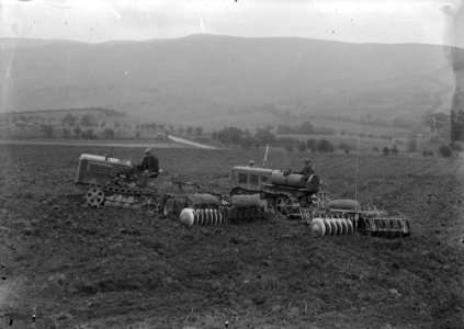 Men harrowing using tractors and disk harrows (1294780)