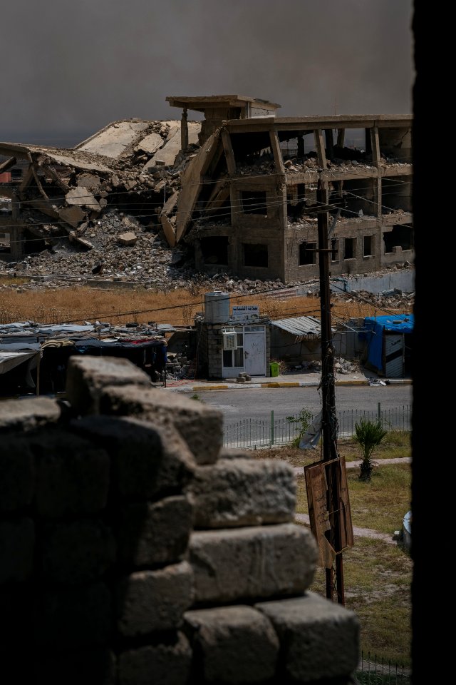Views on 28th June 2019 around the destroyed city center of Shingal while a field fire rages south of the city 19