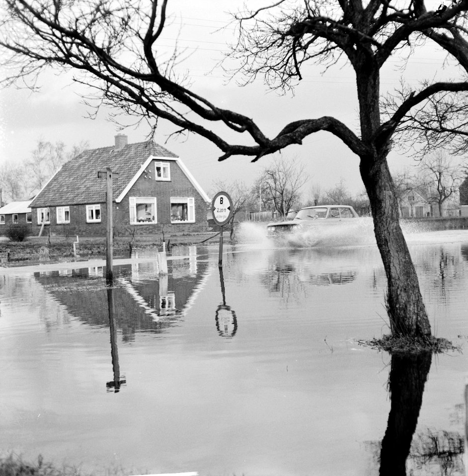 Wateroverlast in de Gelderse Vallei auto die over een ondergelopen weg rijdt, Bestanddeelnr 918-5502