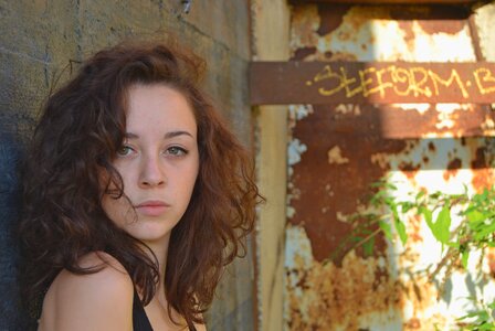 Woman rusty metal wall