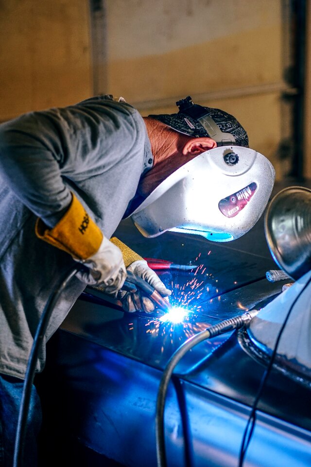 Welder welding blue work