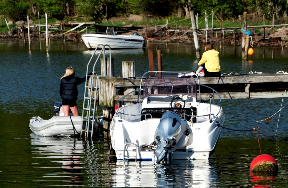 Two girls and boats in Govik harbor