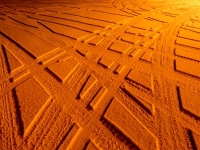 Tire tracks in snow under sodium light 3 photo