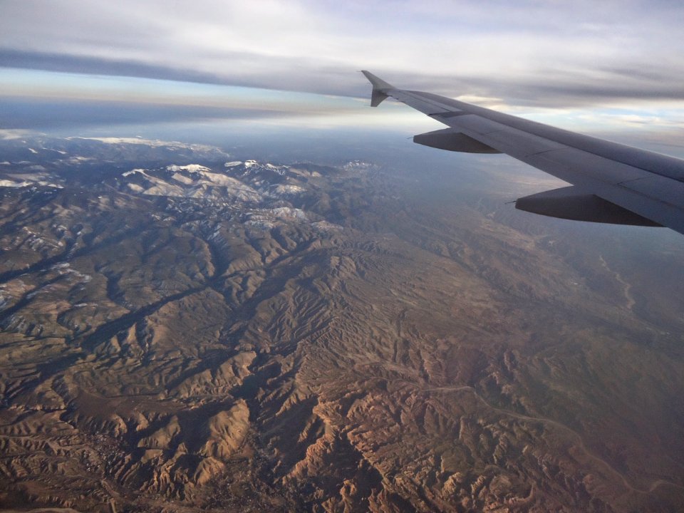 View from plane Rocky Mountains with snow in March