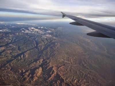View from plane Rocky Mountains with snow in March photo