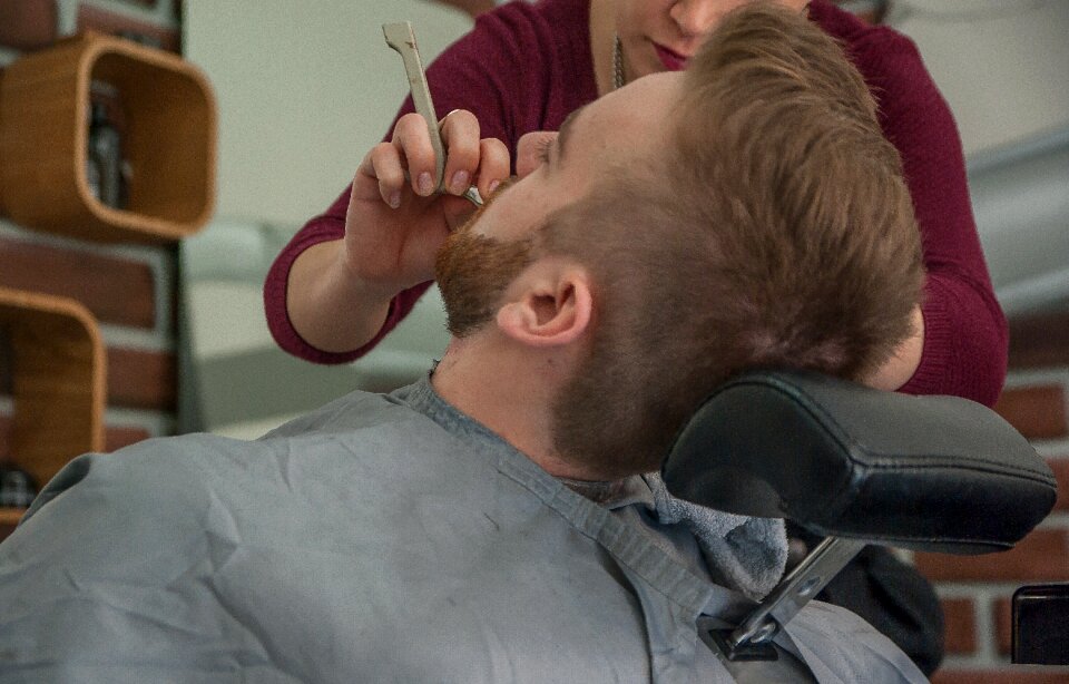 Barber shaving beard