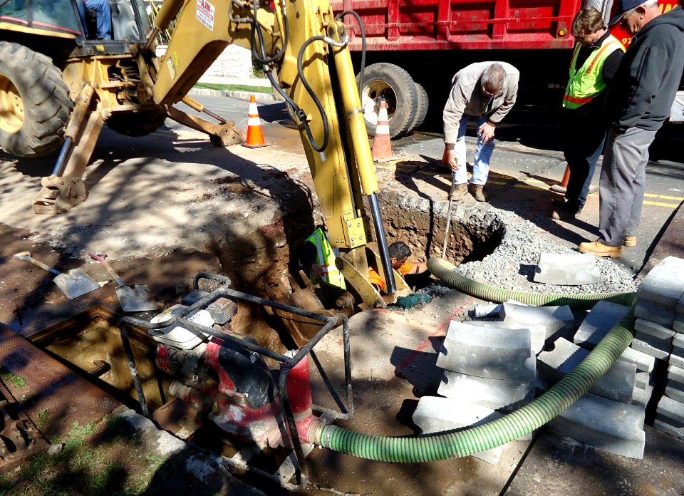 Street repair backhoe digging Summit NJ