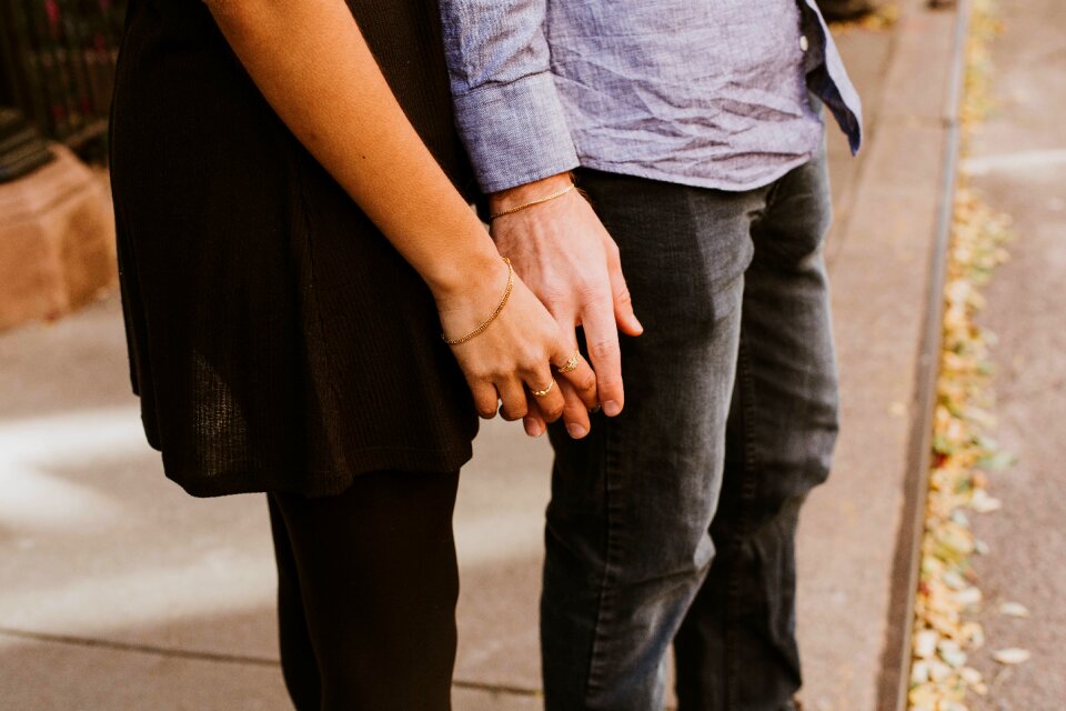 Man woman holding hands