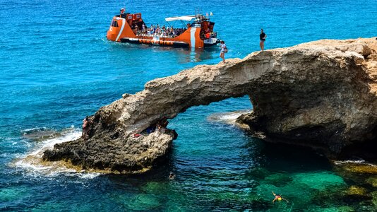 Tourists sightseeing natural arch