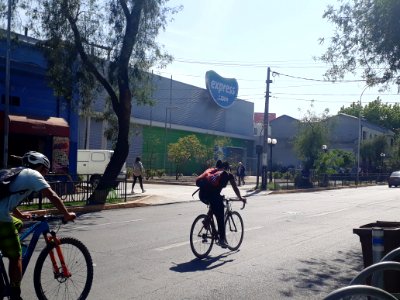 Fila en supermercado junto a negocios abiertos