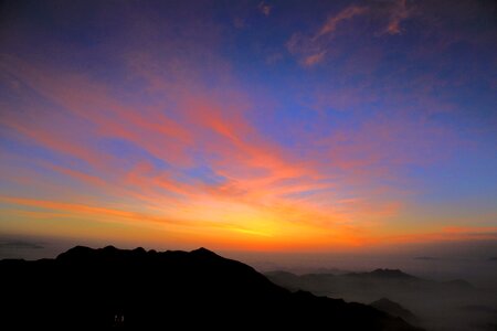 Sunrise clouds four people with
