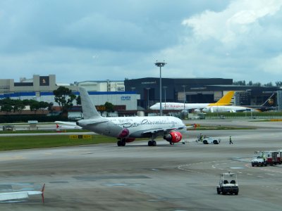 AirAsia Airbus A320-216 9M-AFM Leaving Apron by Tractor in Singapore Changi Airport 20130211