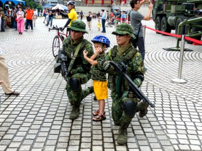 Two ROCA Soliders Kneeling on Ground with Boy 20140607 photo
