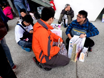 Visitors Sitting on Ground Sharing Collection after Event 20150131