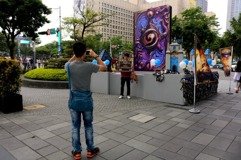 Visitor Photographing Friend with Card Frame behind Event Landmark 20160430