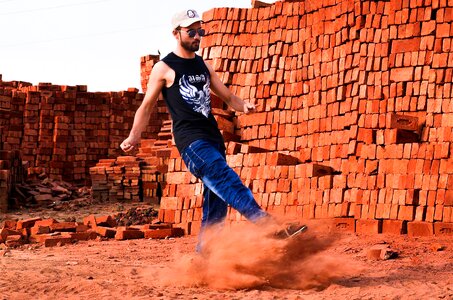 Bricks builders kicking sand photo