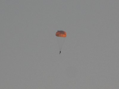 Parachutistover in the rays of the rising sun