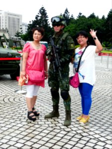 ROC Airborne Special Operations Forces Soldier with Two Women Photographing on Square 20140607