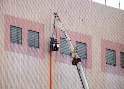 Pipe Workers Working at Out Wall of 13th Floor, Taipei City Minsheng Community Center 20160102a photo