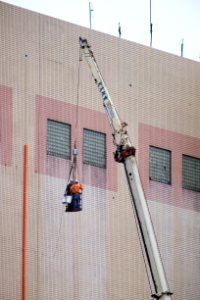 Pipe Workers on Basket Desending by Crane Truck 20160102