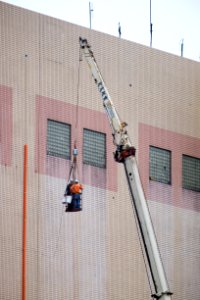 Pipe Workers on Basket Desending by Crane Truck 20160102 photo