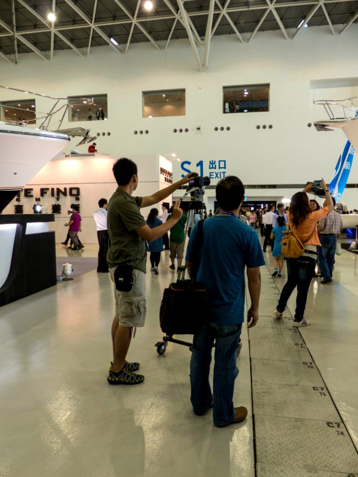 TIBS South Hall Photographer Moving Camera on Wheeled Tripod 20140508