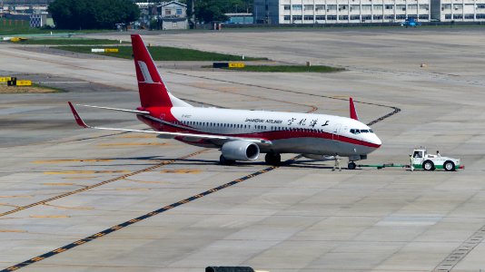 Shanghai Airlines Boeing 737-89P (WL) B-6107 Moving by Tractor at Taipei Songshan Airport Apron 20160924b
