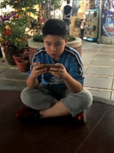 Sitting Boy Playing Samrtphone Game 20180323 photo