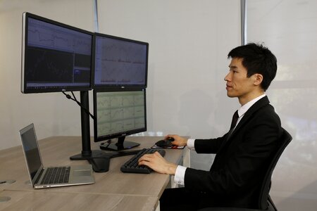 Commercial laptop desk trader in the financial multi-screen