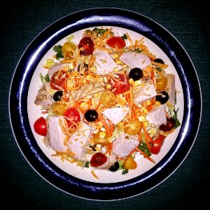 Salad with turkey, cherry tomatoes, black olives, carrots, crisp corn, cheese, and avocado ranch dressing - Massachusetts